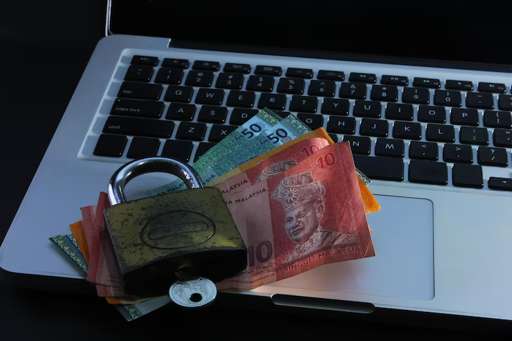 high-angle-view-paper-currency-with-padlock-laptop_1048944-12184417